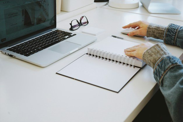 Planning at a desk with a laptop and notebook